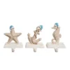 Transpac Coastal Christmas Stocking Holder Set Of 3 Colorful Resin Mantel Decorations For Holiday Decor And Gift Giving